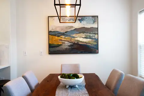 Dining table under a black lantern-style pendant light